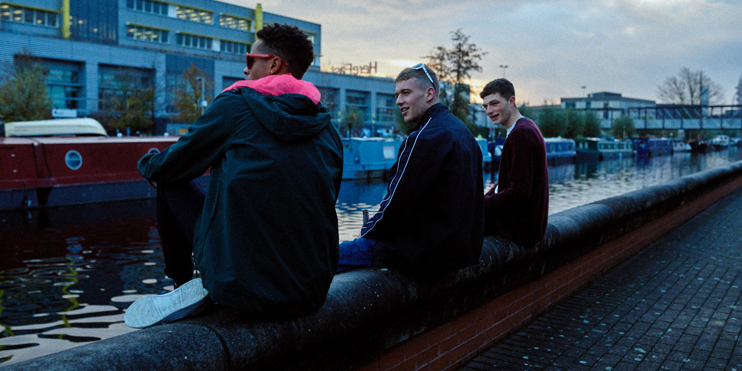3 Lads sit by canal by lifestyle photographer Tim Cole
