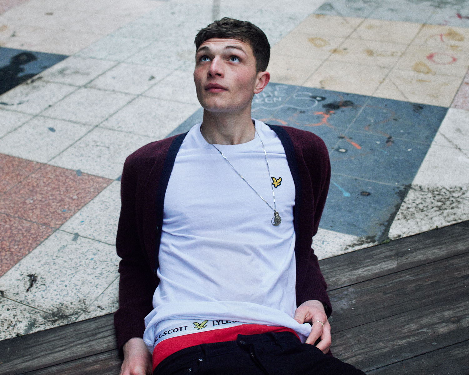 Lad in  lies on ground by lifestyle photographer Tim Cole