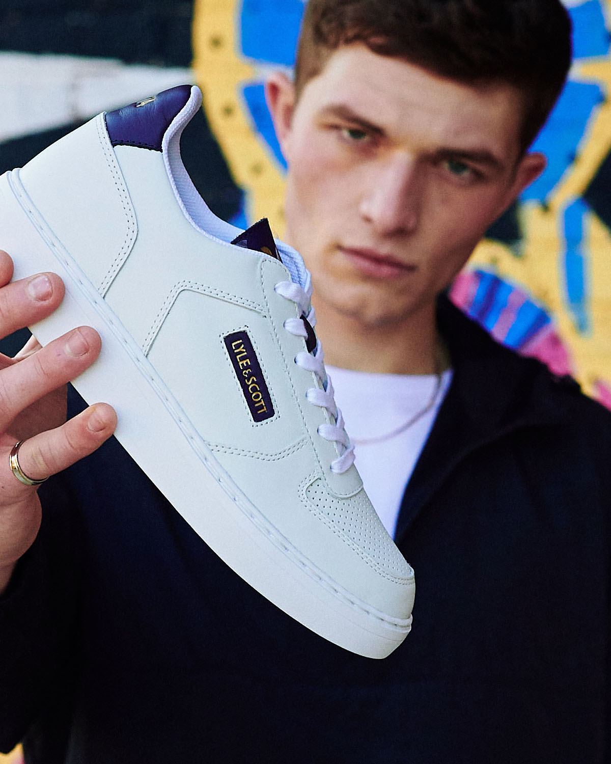 Lad holds shoe by lifestyle photographer Tim Cole