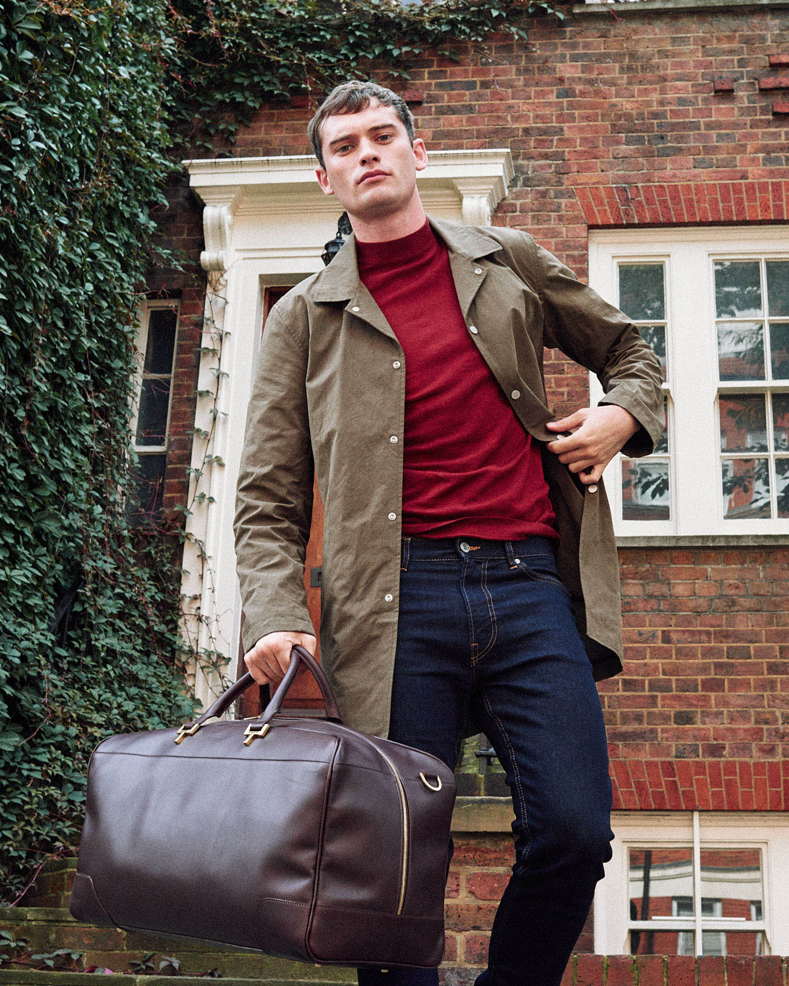  man holds leather holdall by lifestyle photographer 