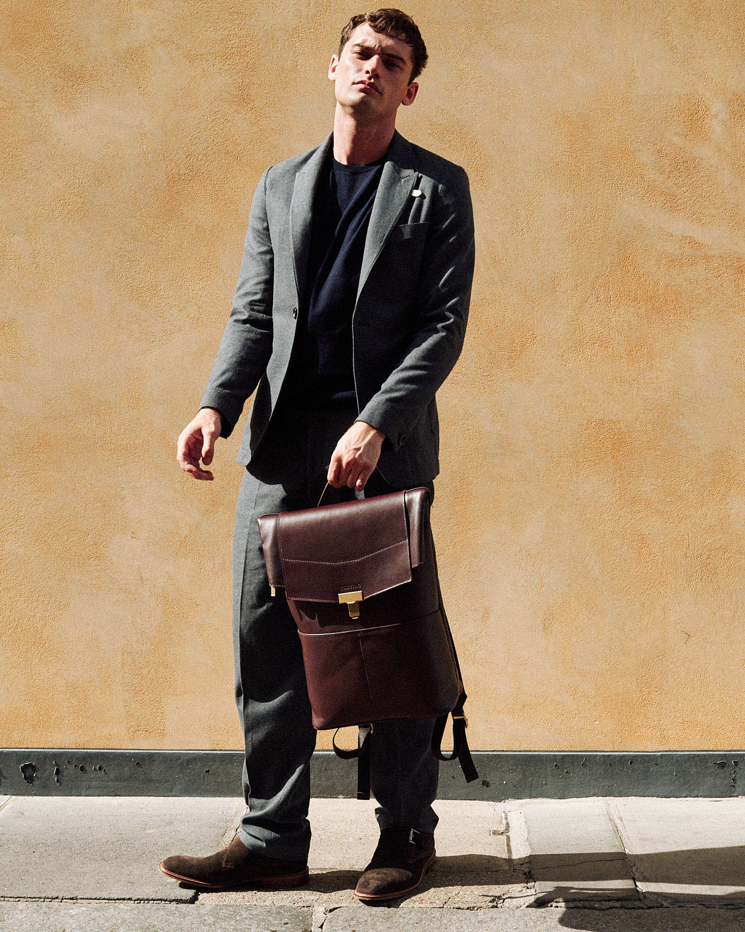  man, bag, orange wall by lifestyle photographer Tim Cole 