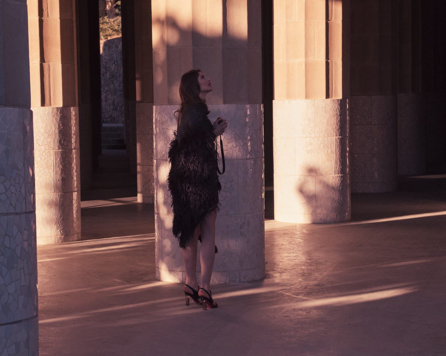 Woman, golden columns by lifestyle photographer Tim Cole