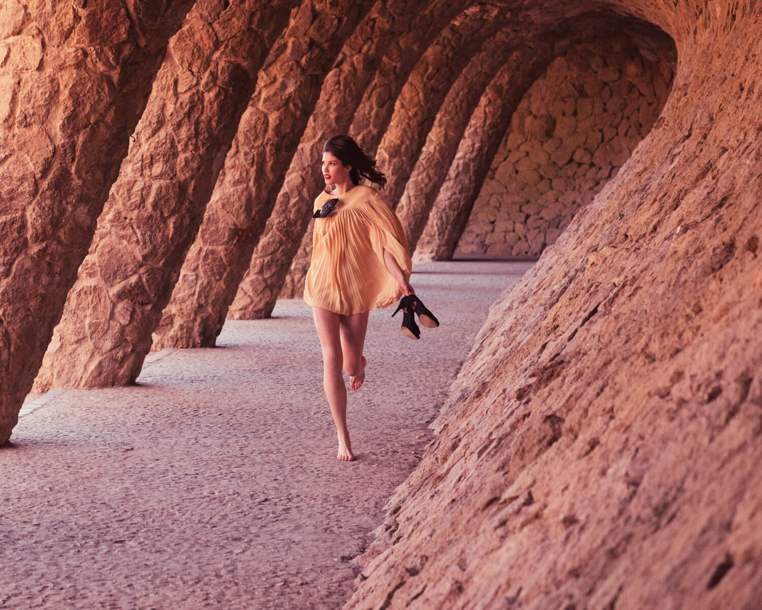 Woman, runs  in Park Güell by lifestyle photographer Tim Cole