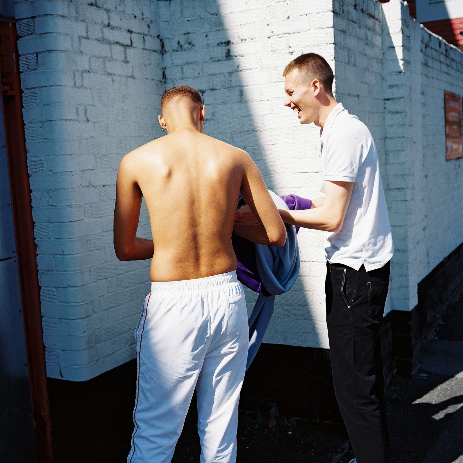 Two lads change their tops by lifestyle photographer Tim Cole 