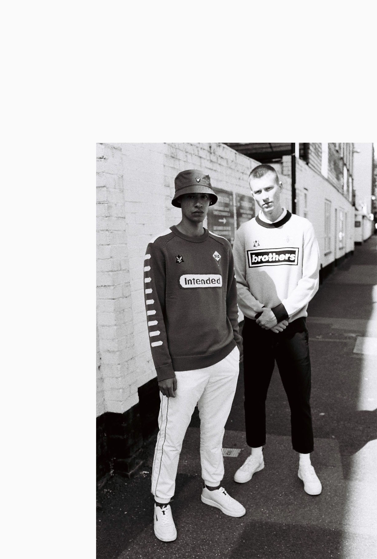 B/W, 2 Lads outside  ground by lifestyle photographer Tim Cole 