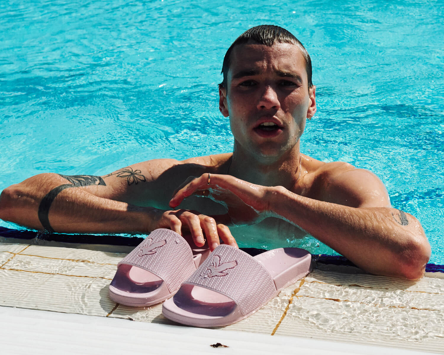 Lad in outdoor pool  by  lifestyle photographer london Tim Cole 
