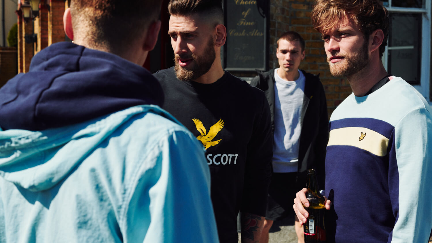 lads stand outside pub by lifestyle photographer 