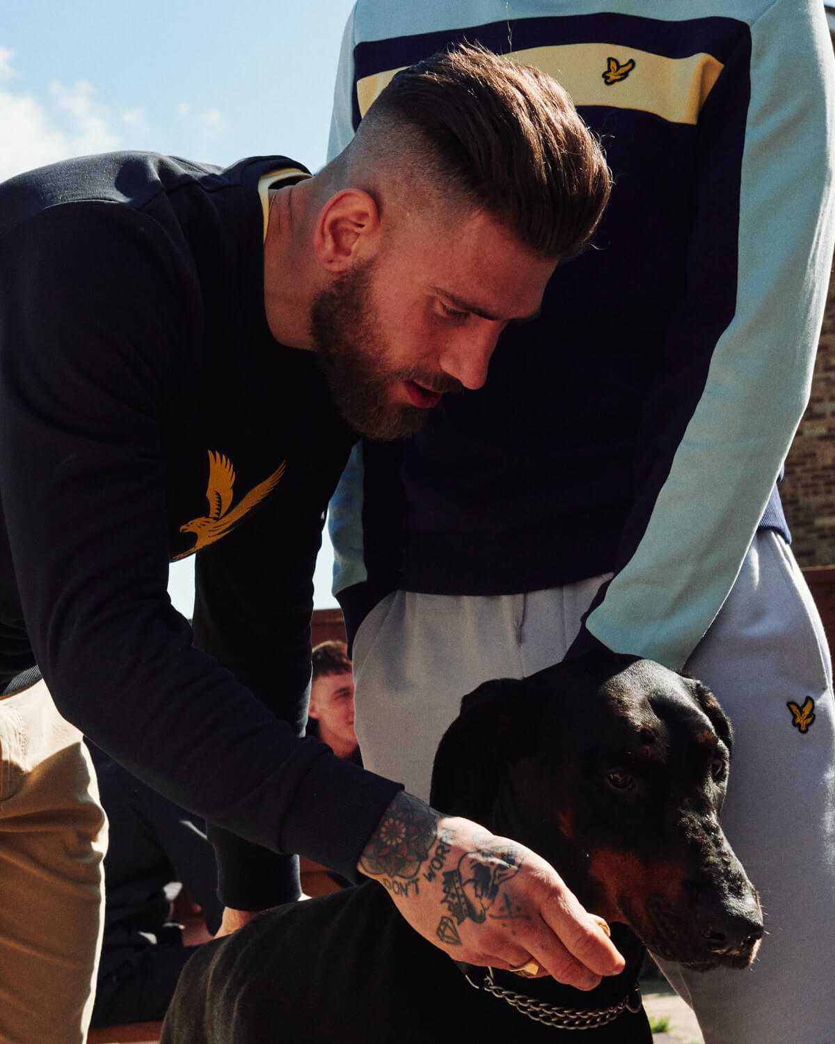 lad pets dog, by lifestyle photographer london