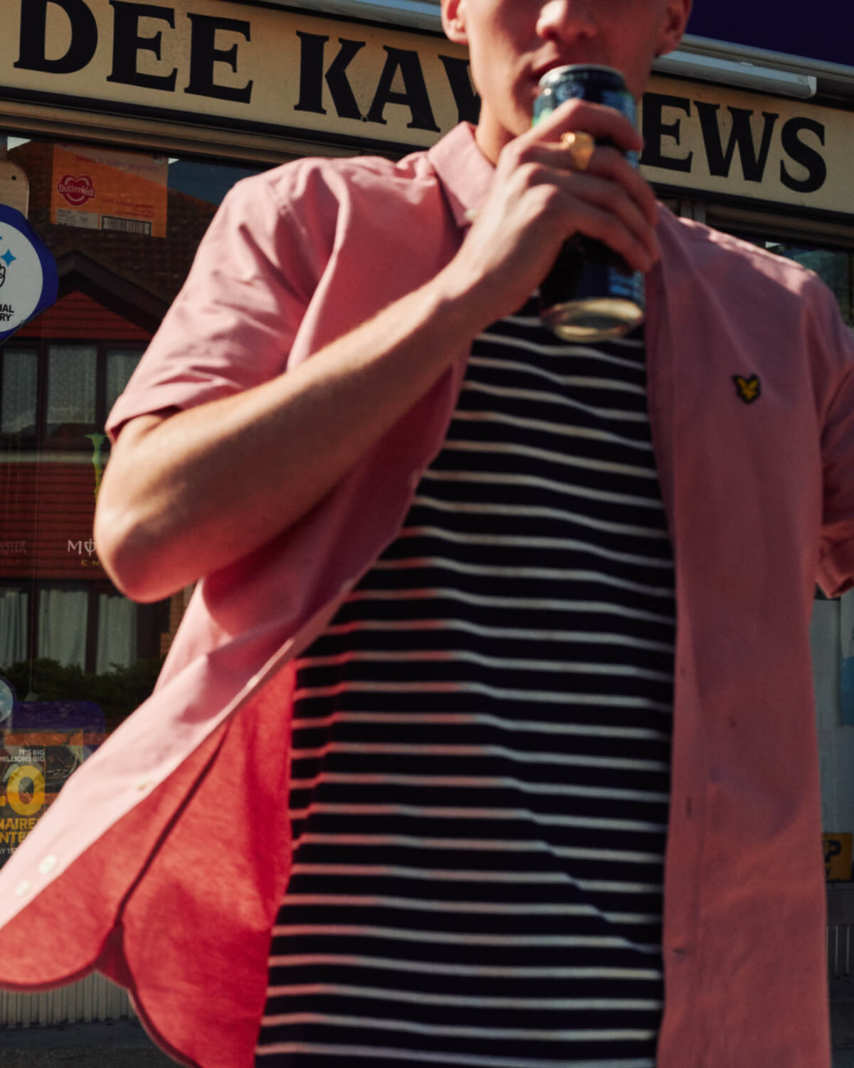 Lad by newsagent shop, by lifestyle photographer 