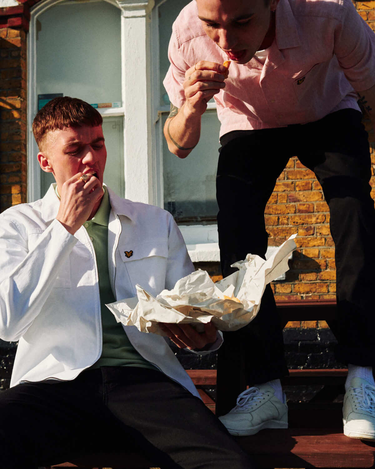 Two lads eat chips, by lifestyle photographer 