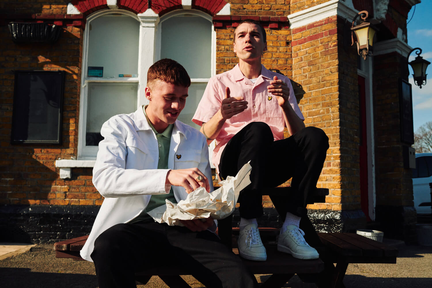 Two lads sit outside pub, by lifestyle photographer 