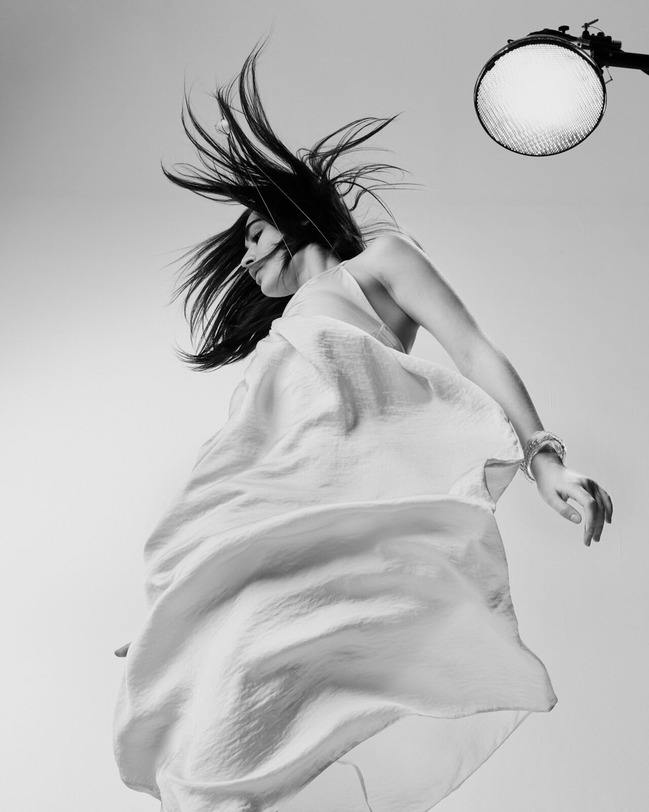 Young woman, white dress, by lifestyle photographer Tim Cole 