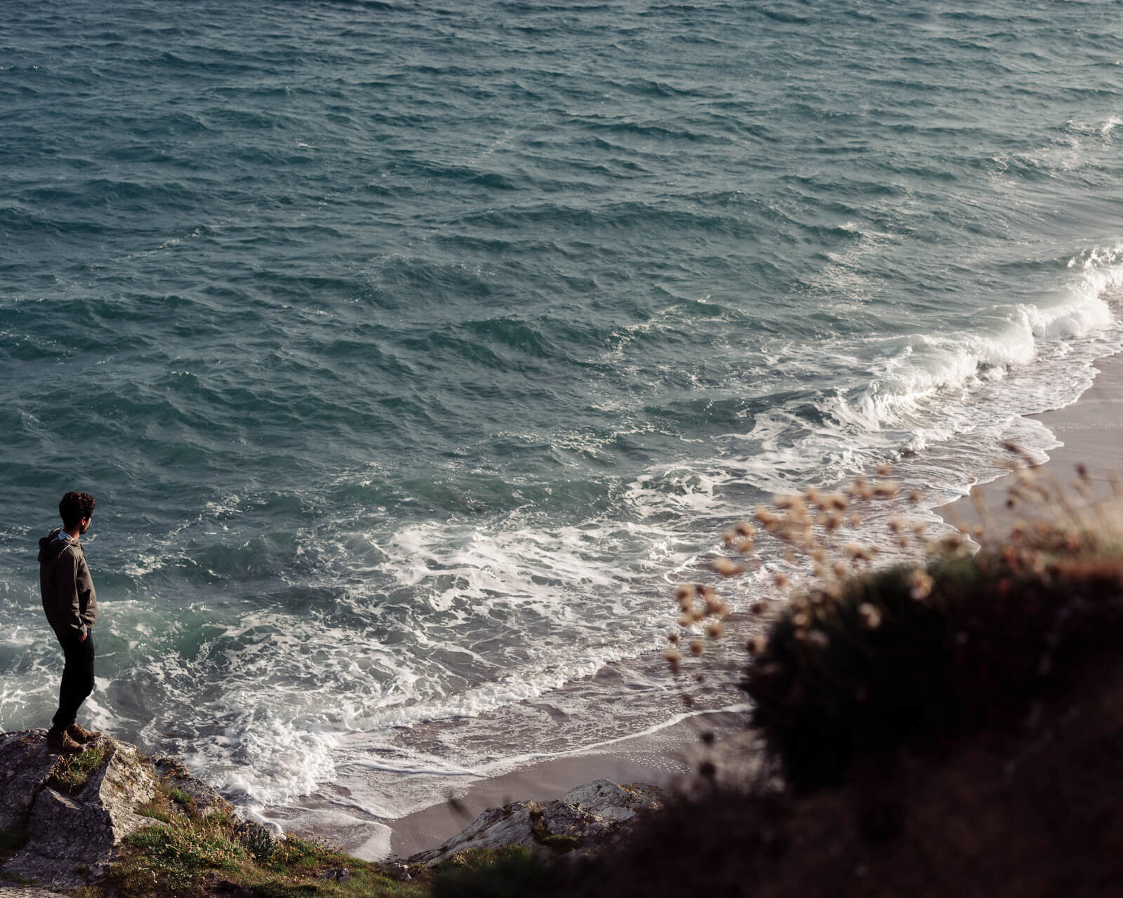  Lifestyle photographer Tim Cole shoots man  on sea cliff