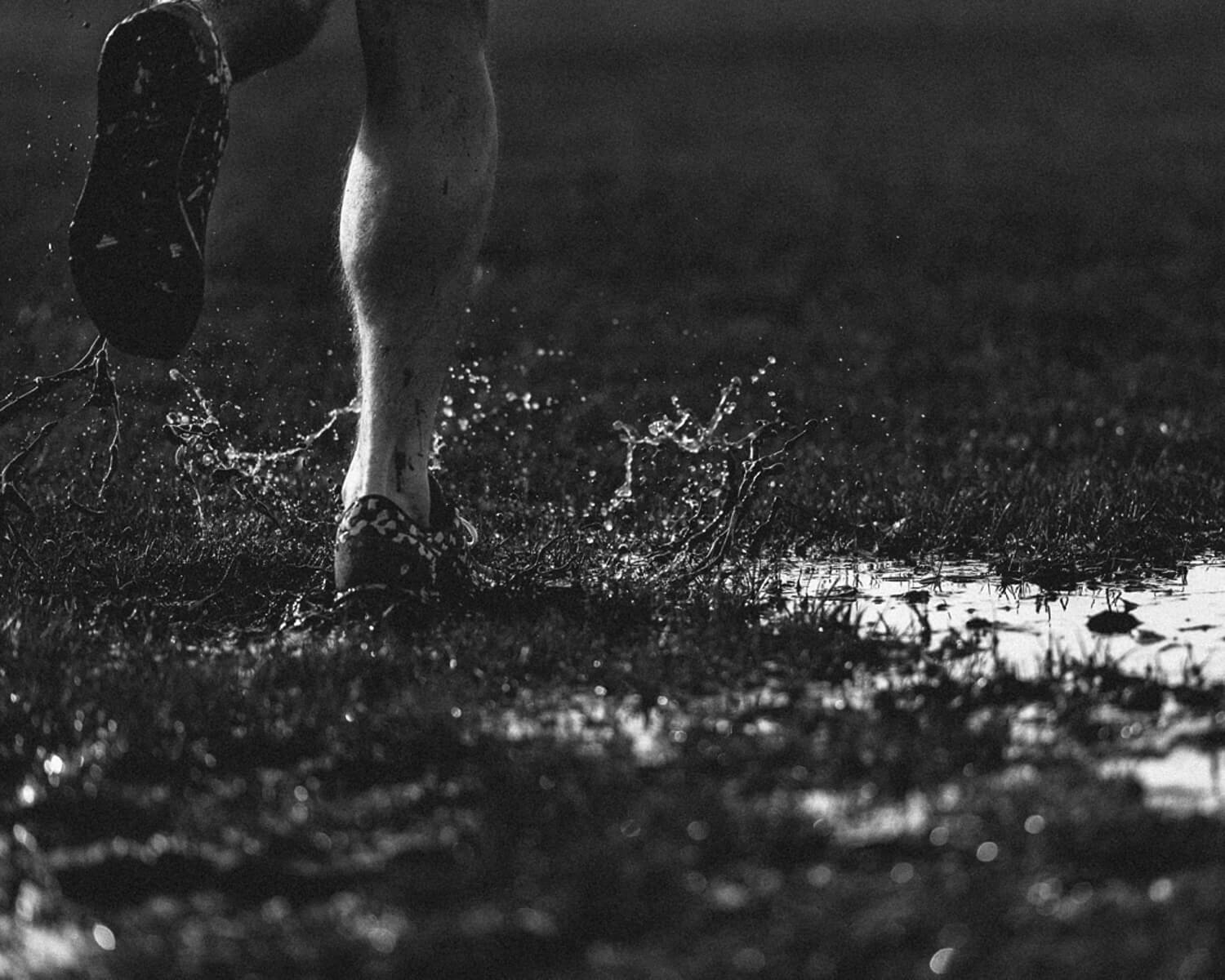  run in muddy field by lifestyle photographer Tim Cole