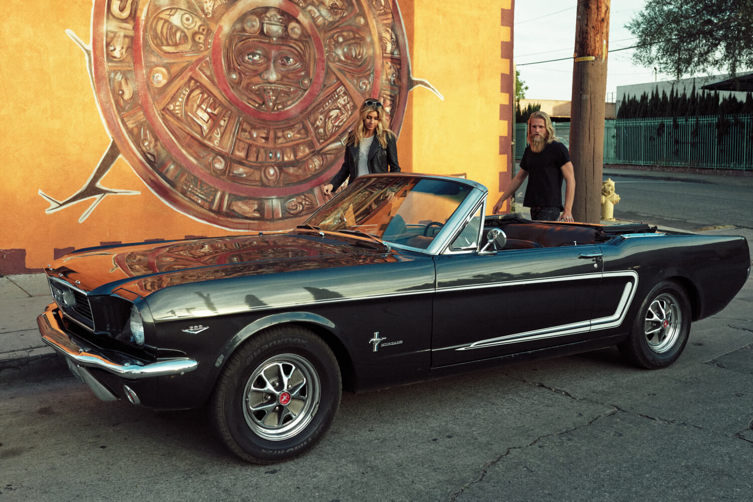 hipsters with black mustang  by lifestyle photographer Tim Cole