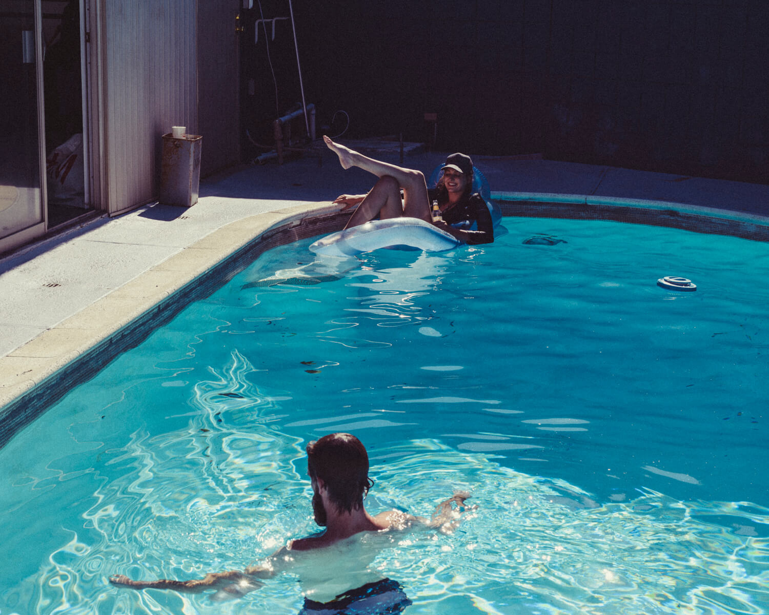 Hipsters at outdoor pool girl  by lifestyle photographer Tim Cole