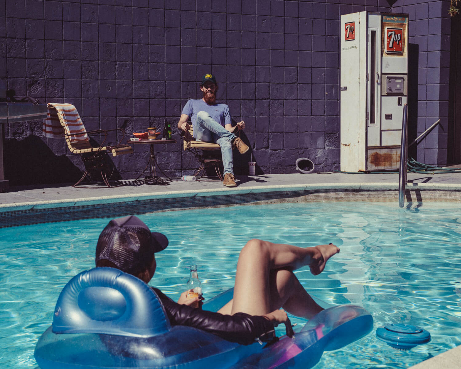 Hipster on inflated lounger, by lifestyle photographer Tim Cole