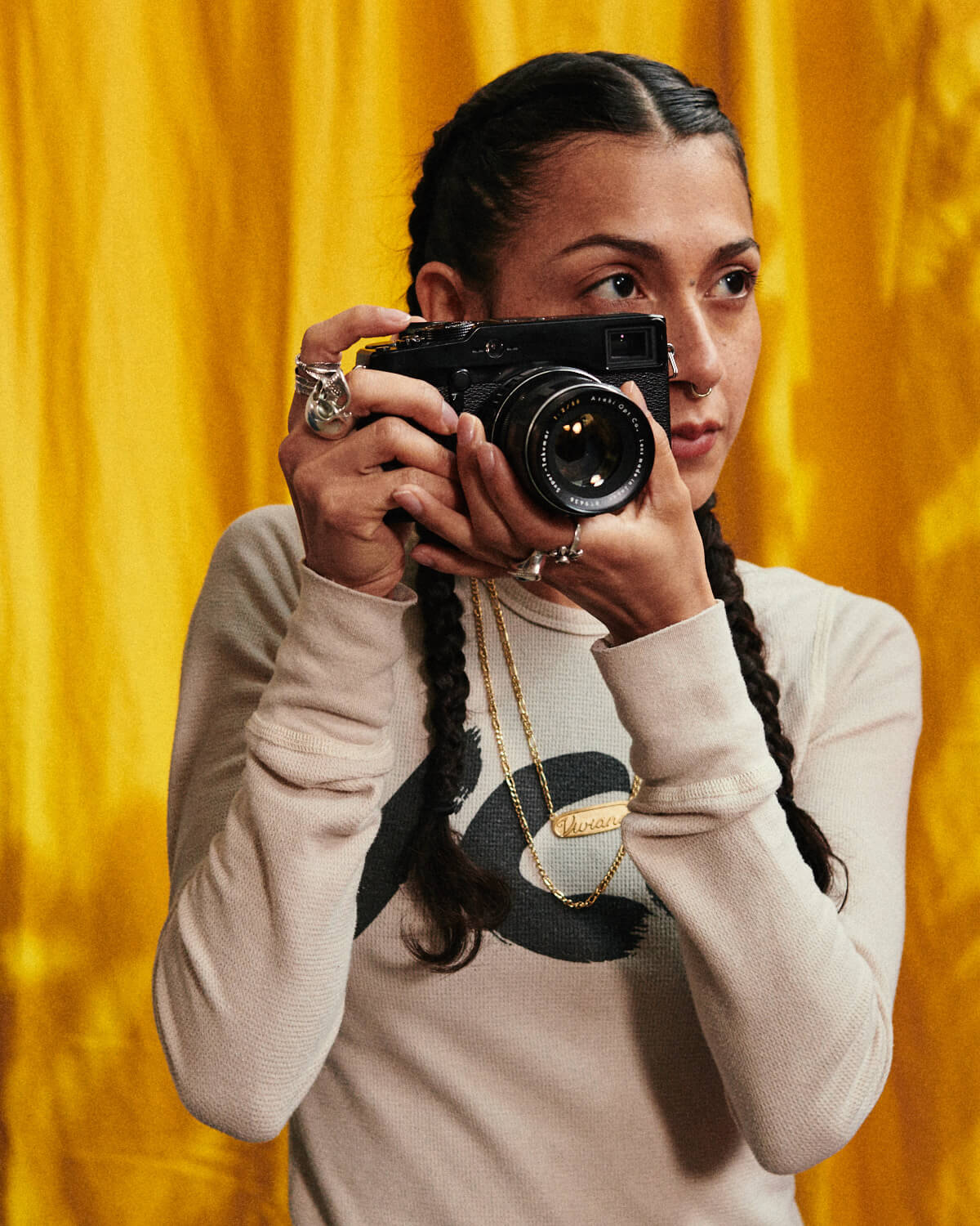 Girl, holds camera by lifestyle photographer Tim Cole