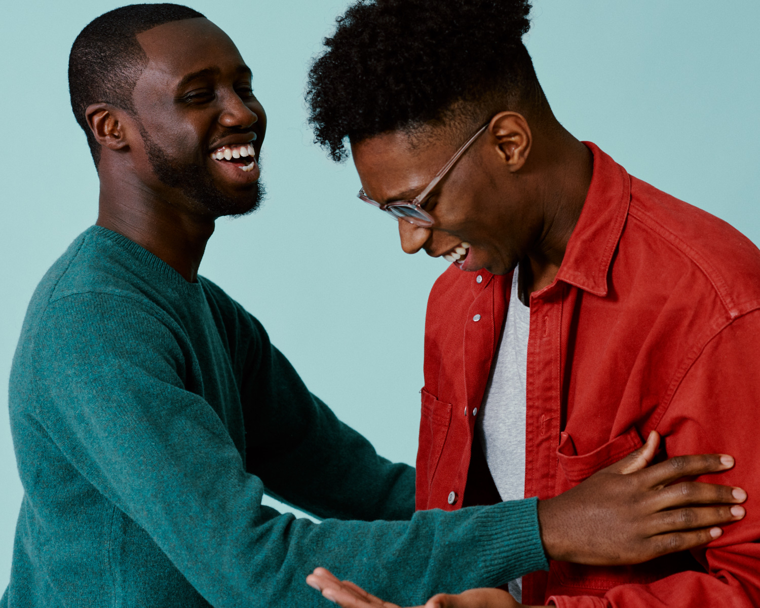 Two Amos Bursary  men hug and laugh, by portrait photographer 