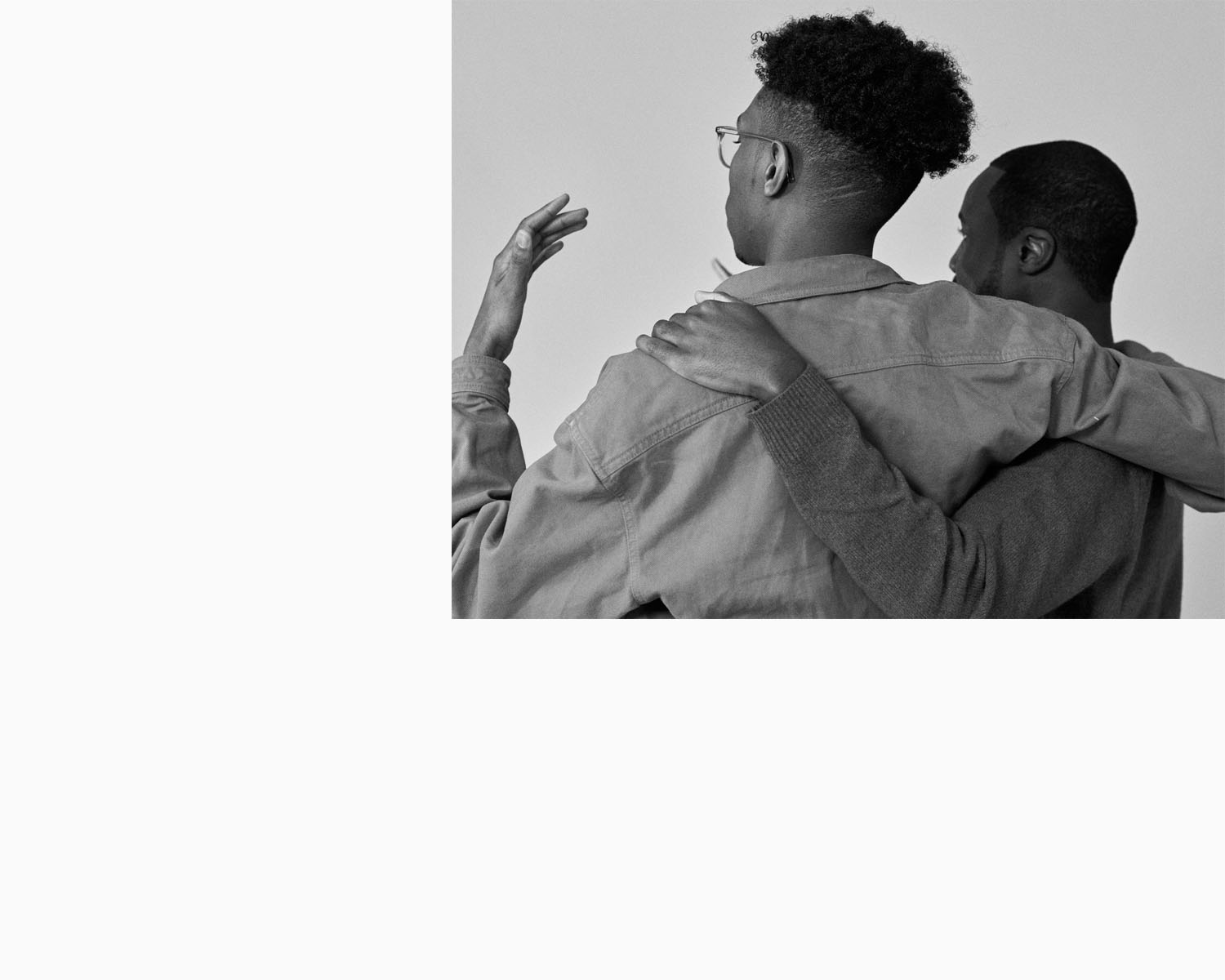 Amos Bursary men hold each other, by portrait photographer