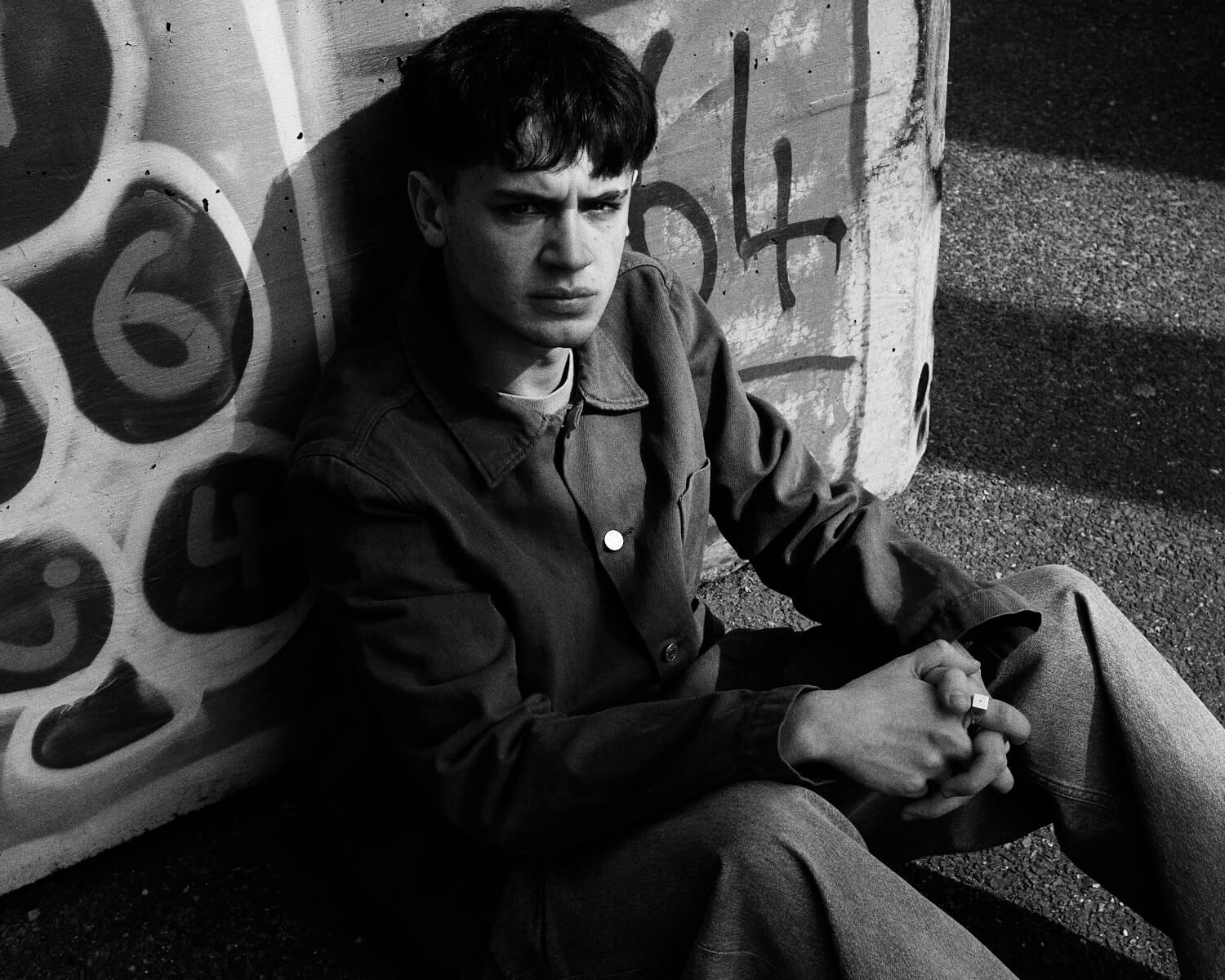 Teenage boy, on floor by  portrait photographer Tim Cole