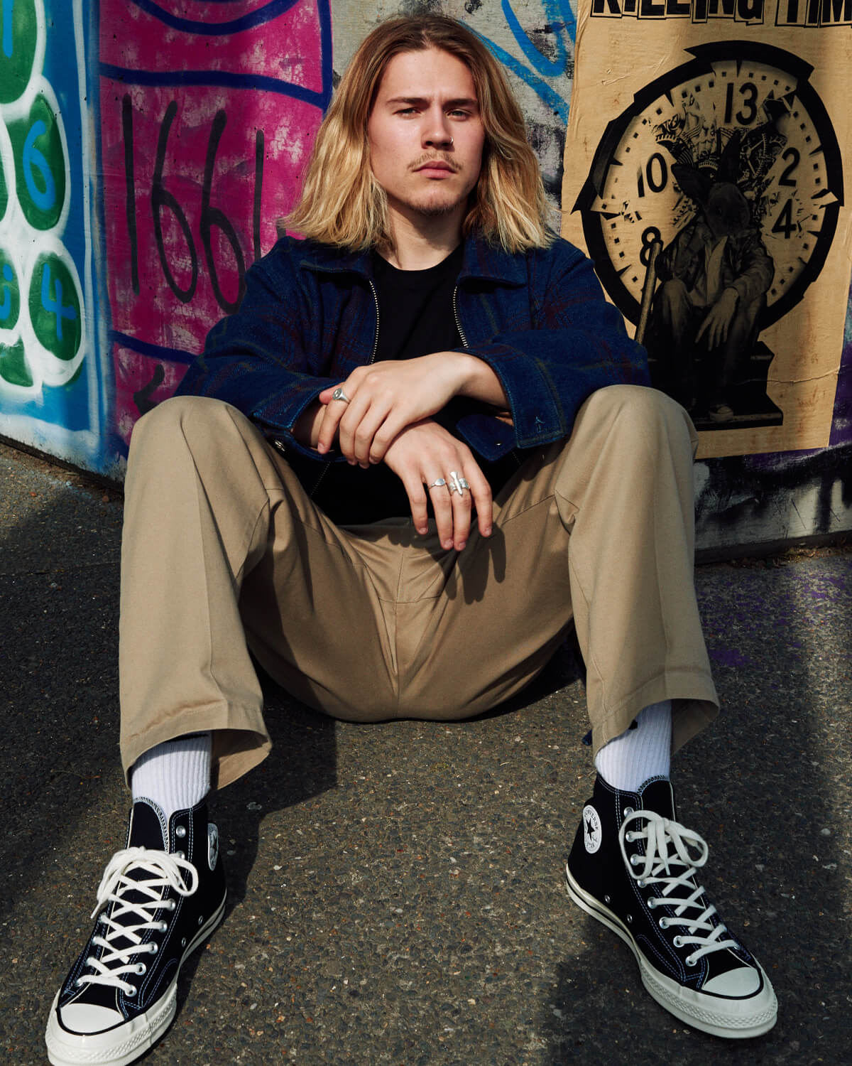 Teenage boy sits on floo by portrait photographer Tim Cole